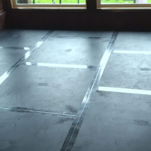SmartCells Fall protection flooring installed as an underlayment with carpet over top