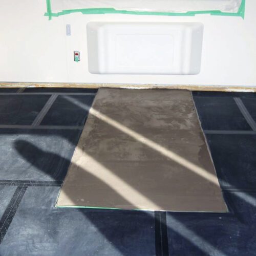 SmartCells tiles being installed as an underlayment in a medical facility