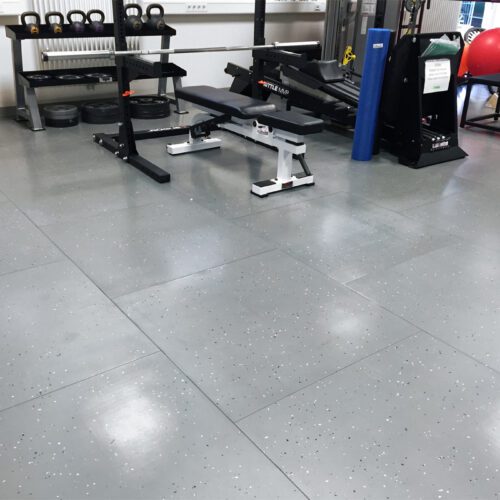 Smartcells Physical Therapy flooring with weightlifting equipment