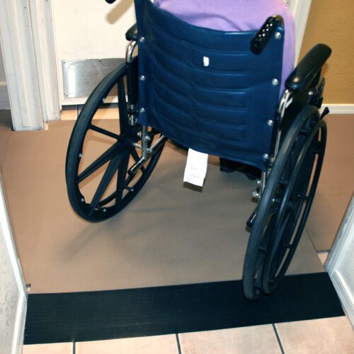 wheelchair being rolled on top of SmartCells fall protection modular flooring