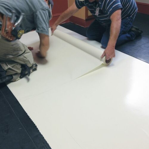 SmartCells tiles being installed as an underlayment in a medical facility