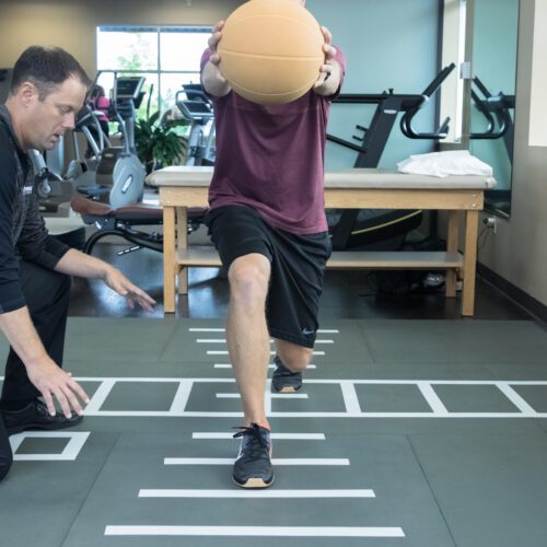 Patient doing rehab exercises on the Smartcells Physical Therapy mat