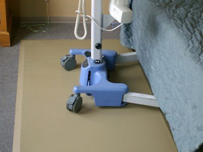 Healthcare equipment on top of a SmartCells mat next to a bed