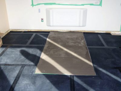 SmartCells tiles being installed as an underlayment in a medical facility