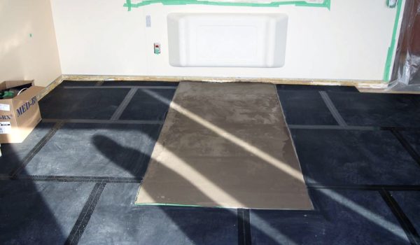 SmartCells tiles being installed as an underlayment in a medical facility