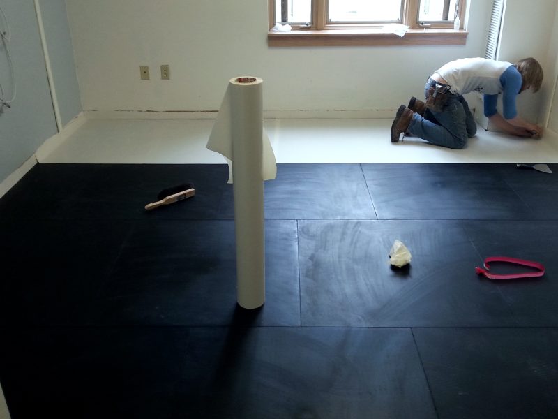 Workers installing an overlayment to go over Smartcells Fall Protection flooring