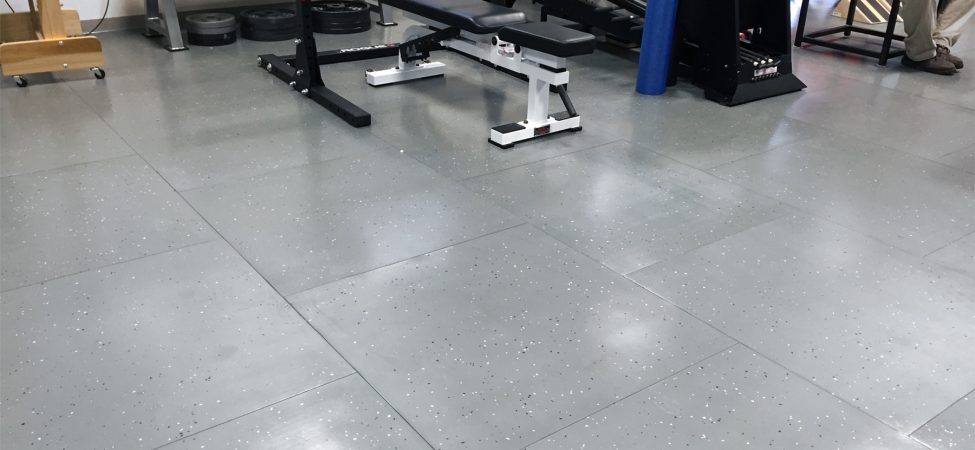 Smartcells Physical Therapy flooring with weightlifting equipment
