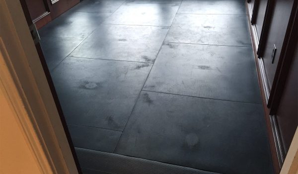 SmartCells Fall protection flooring installed as an underlayment with carpet over top