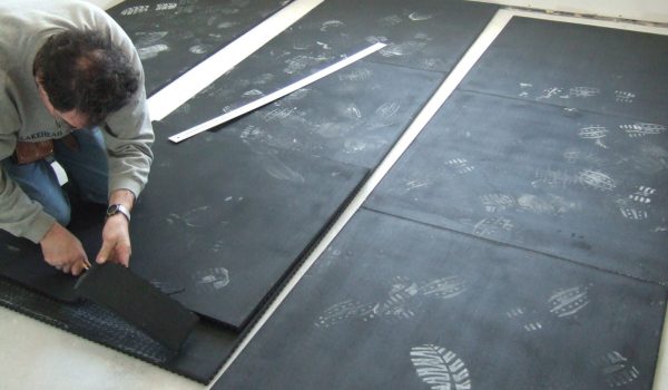 SmartCells tiles being installed as an underlayment in a medical facility