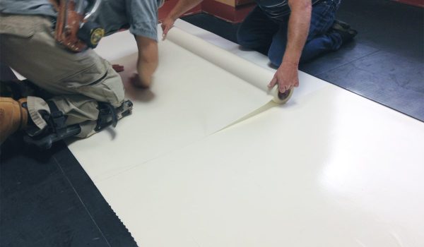 SmartCells tiles being installed as an underlayment in a medical facility