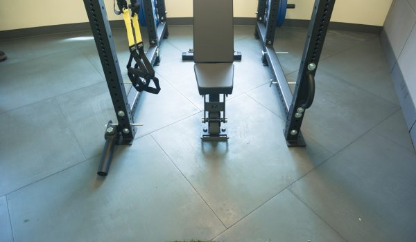 Weightlifting equipment sitting on top of SmartCells physical therapy flooring