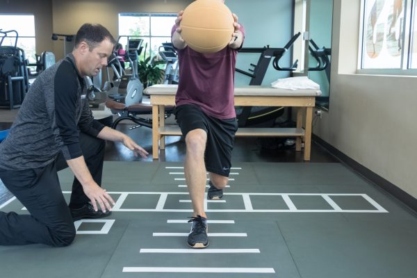 Patient doing rehab exercises on the Smartcells Physical Therapy mat
